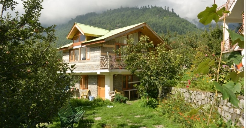 The homestay lies surrounded by apple orchards and green mountains