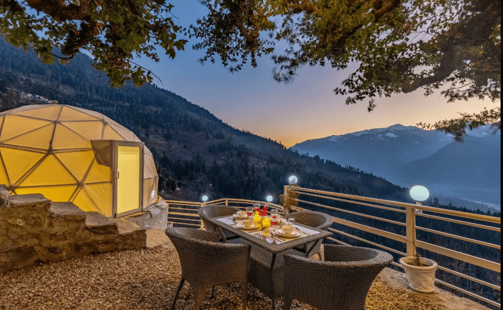 SaffronStays Interstellar in Manali. Private outdoor dining terrace with geodesic dome and panoramic Himalayan valley view at a SaffronStays villa in Manali