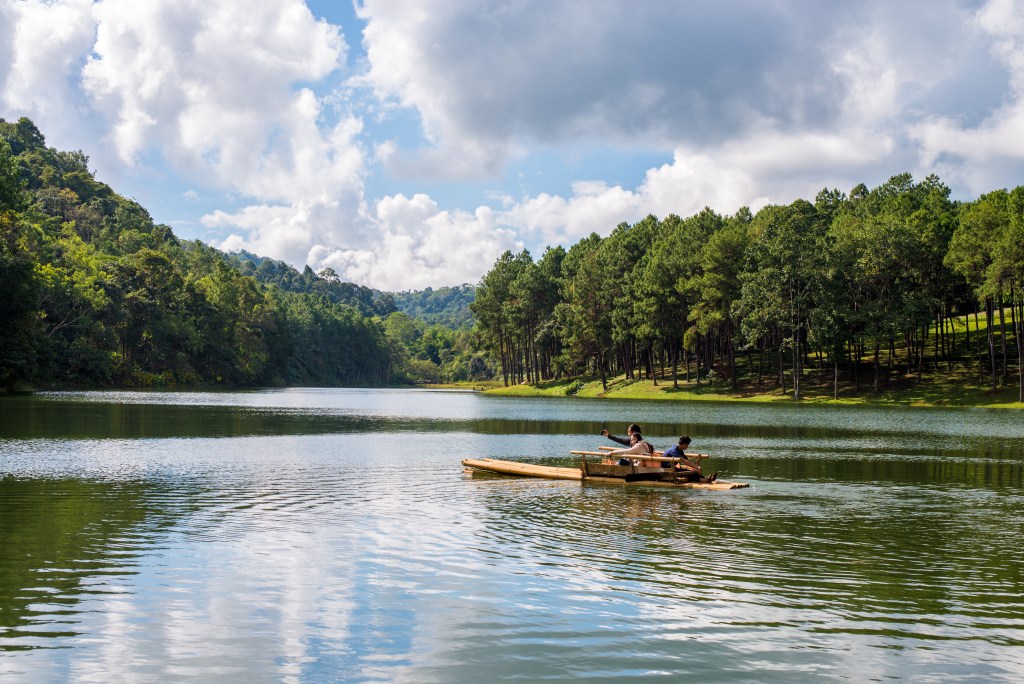 Misty morning view over Ooty Lake in the Nilgiris, Tamil Nadu in June with lush green hills surrounding the water