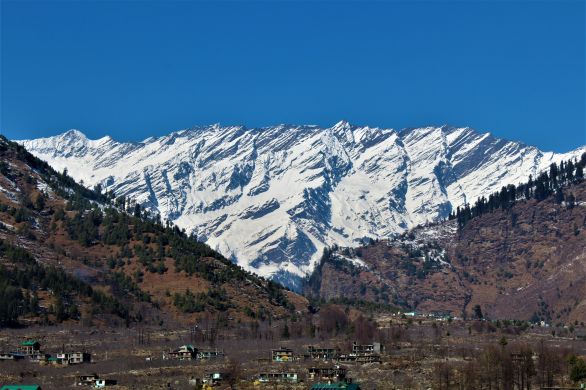 Panoramic view of snow-capped Himalayan mountain range above Kullu Valley near Manali in Himachal Pradesh