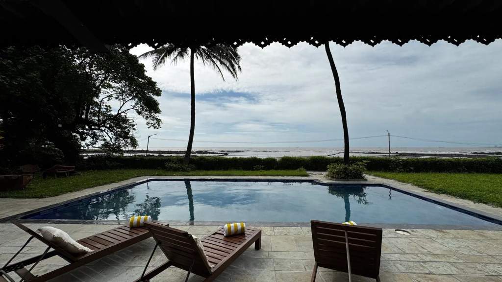 SaffronStays Lighthouse by the Sea villa exterior with private pool and sea view in the background, Sasawane Beach, Alibaug