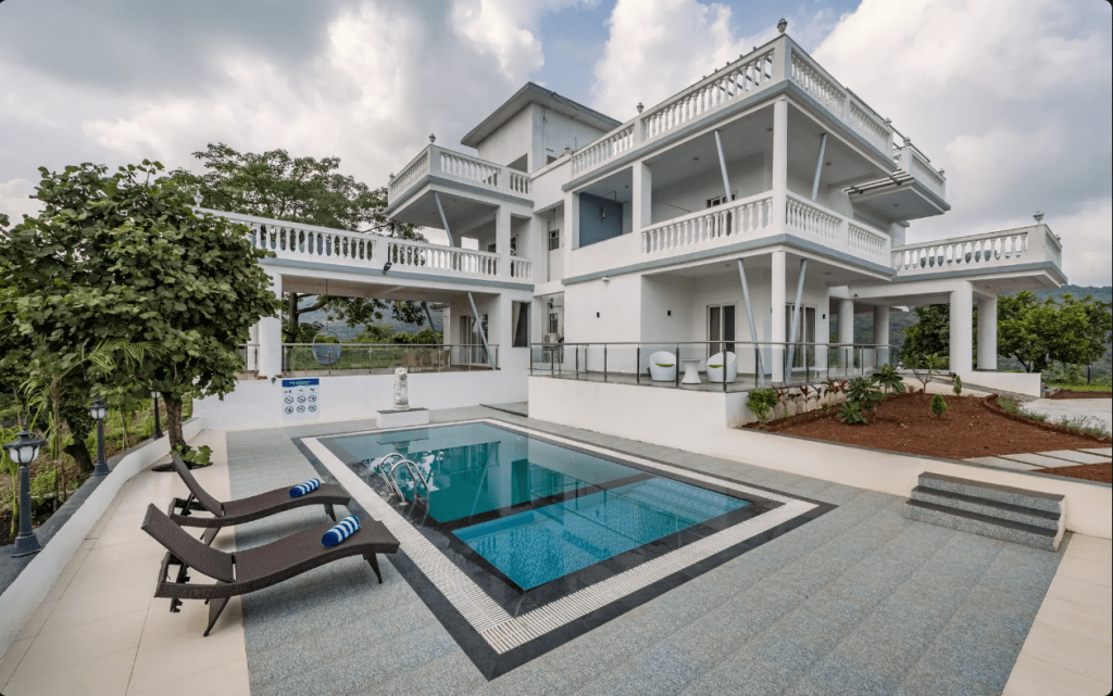 Private pool and hillside lawns at Ivory Mansion, a SaffronStays villa near Pen, Maharashtra
