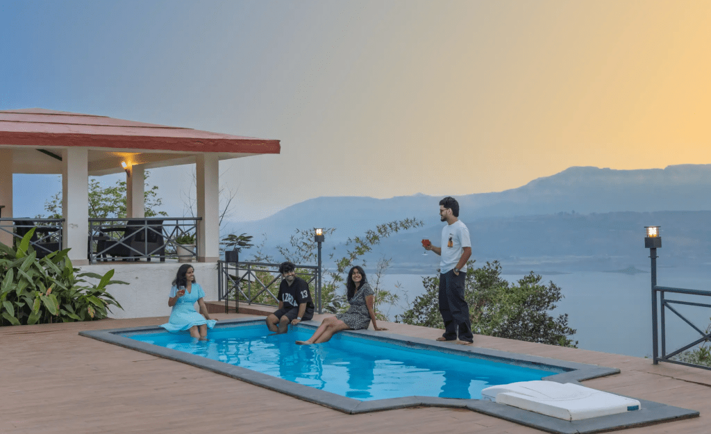 Private pool villa terrace in the rain with monsoon hills in the background