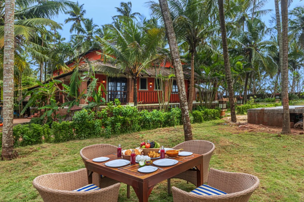 SaffronStays Blue Flag House beachfront exterior with private pool, Hejamady, monsoon sky. 